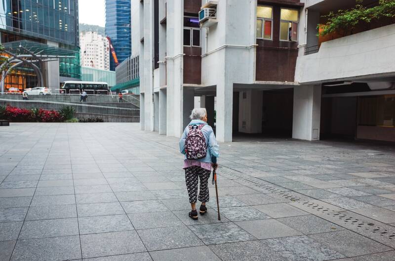 Alte Frau läuft durch eine Stadt